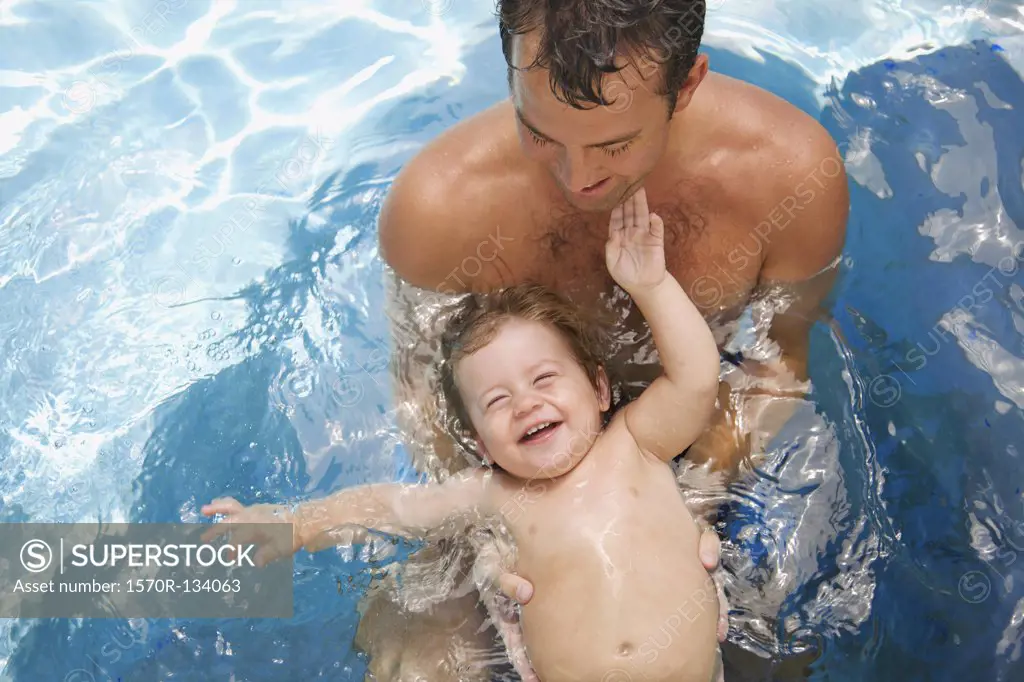 A man and a baby boy in a swimming pool