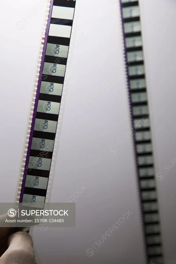 Detail of a man holding a strip of film