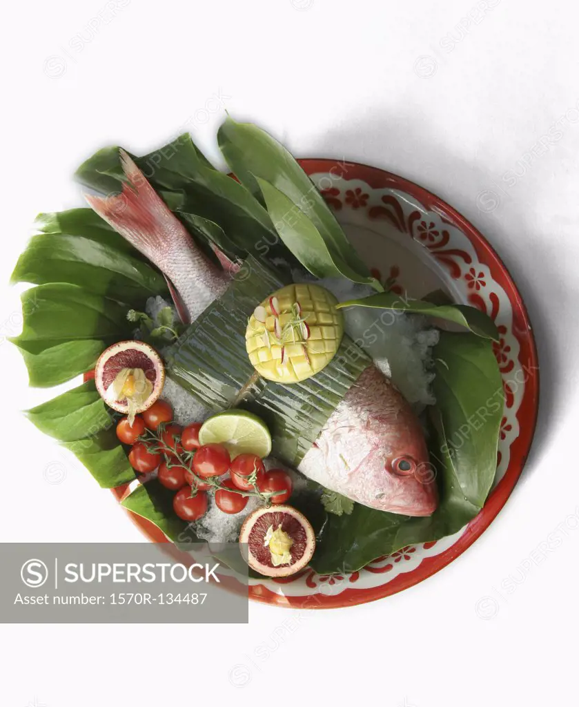 Red snapper wrapped in a banana leaf with garnish