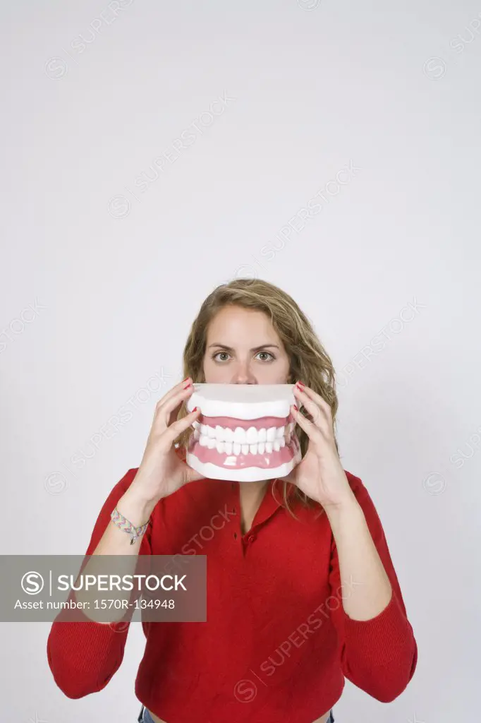 Woman holding large closed teeth