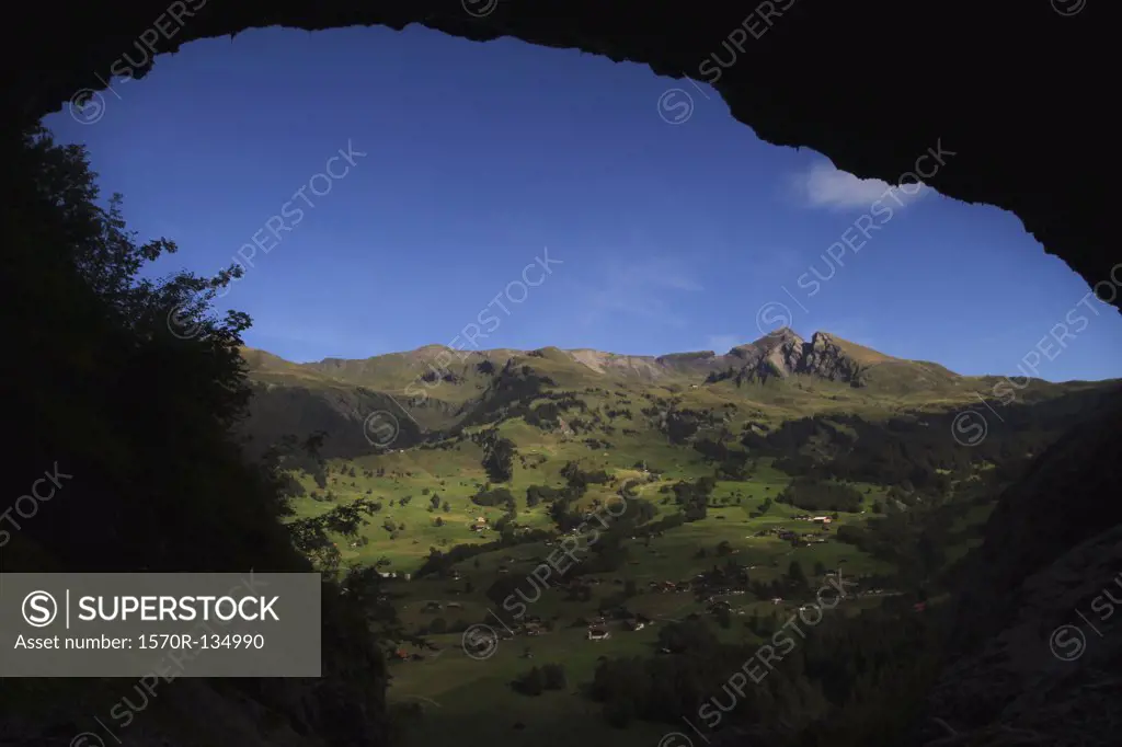 Swiss rural landscape framed by an arched rock