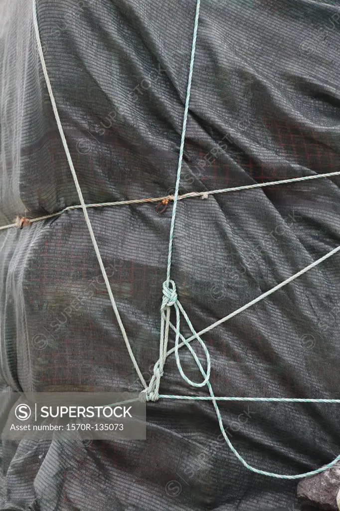Detail of a tarpaulin and ropes