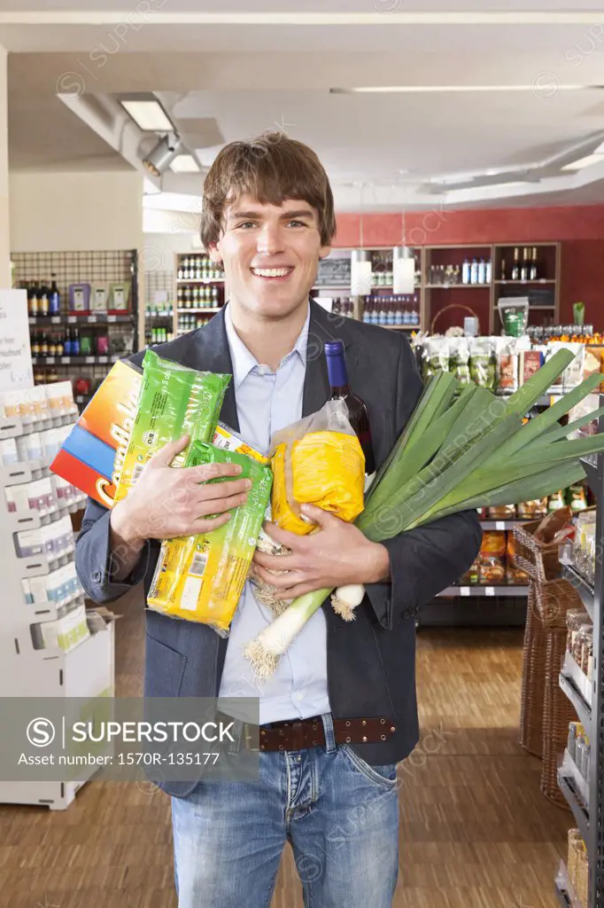 A man with an armful of groceries