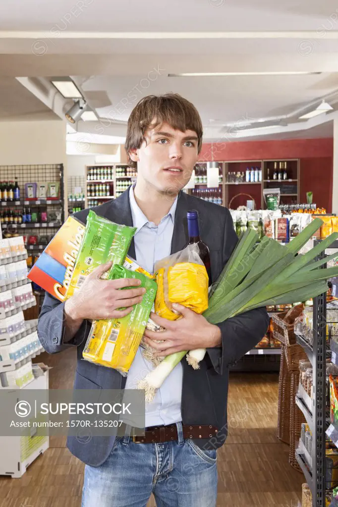A man with an armful of groceries
