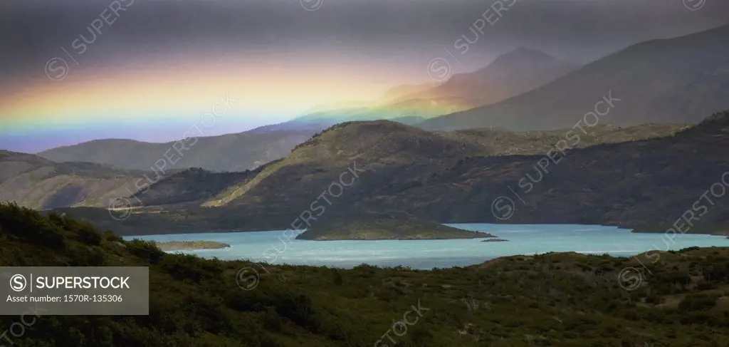 View of a rainbow over mountains and a lake, Torres del Paine National Park, Chile