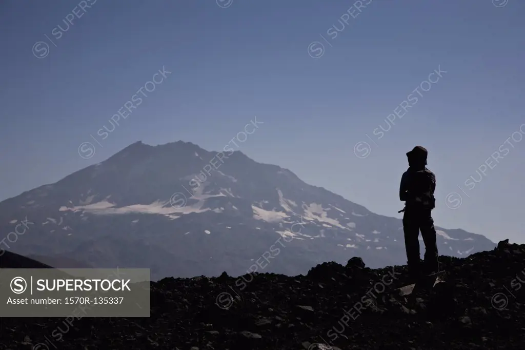 Rear view of a woman looking at a mountain view, Lonquimay Volcano, Patagonia, Chile
