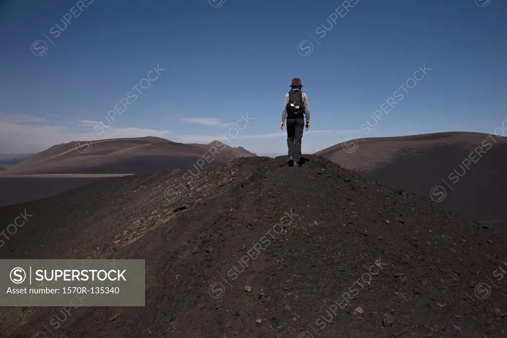 Rear view of a woman hiking over Lonquimay Volcano, Chile