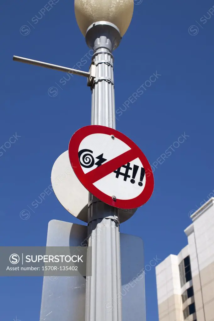 A no swearing sign posted on a street light