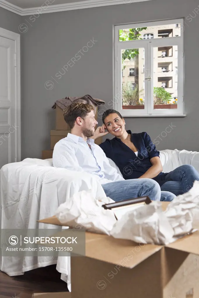 A couple relaxing on a sofa