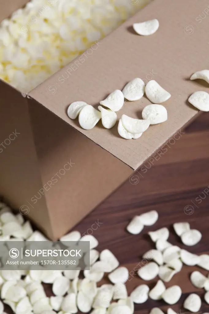 A cardboard box and packing peanuts