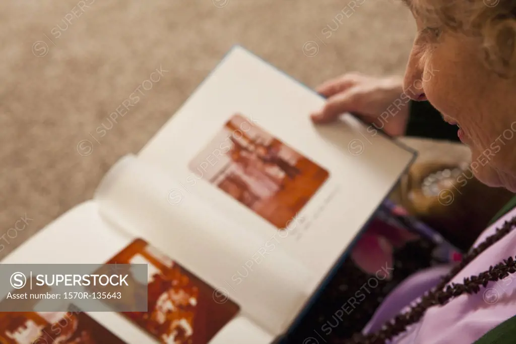 A senior woman looking at a photo album