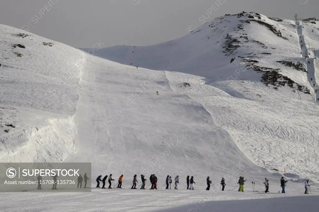 A line of skiers waiting for the ski lift, Oberalp Pass, Andermatt, Uri Canton, Switzerland