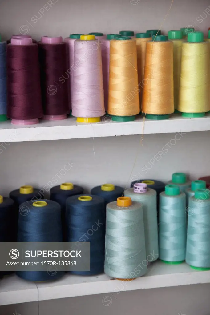 Spools of colored cotton thread on shelves