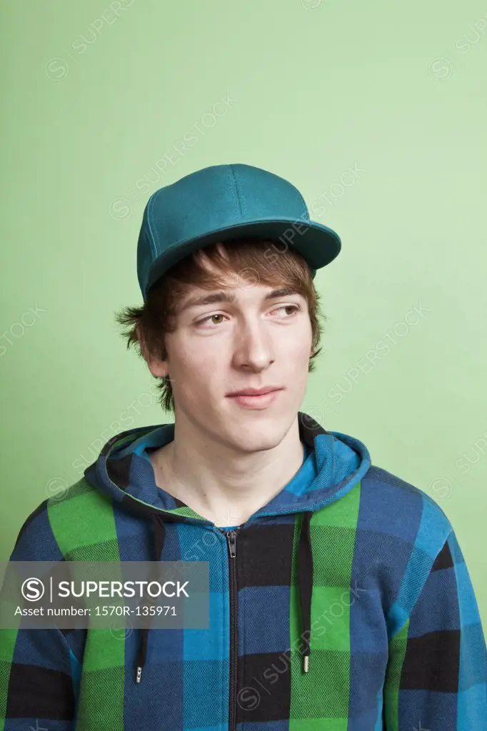 A teenage boy looking off to the side with curiosity, portrait, studio shot