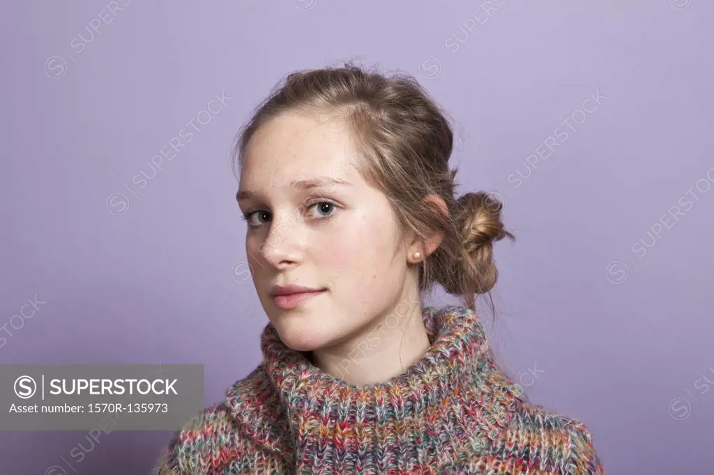 A teenage girl give a sideways glance to the camera, portrait, studio shot