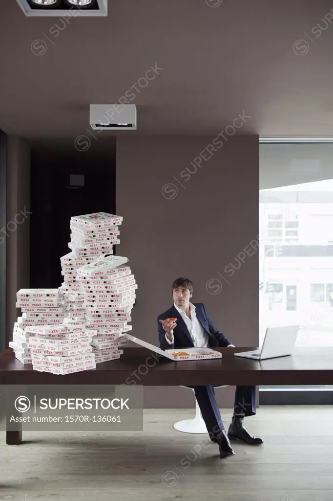 Many pizzas on table for businessman working at home.