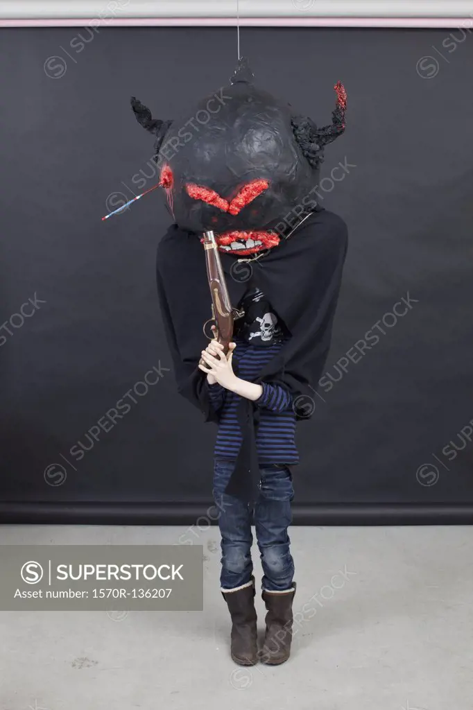 Kid with Halloween outfit and pistol.