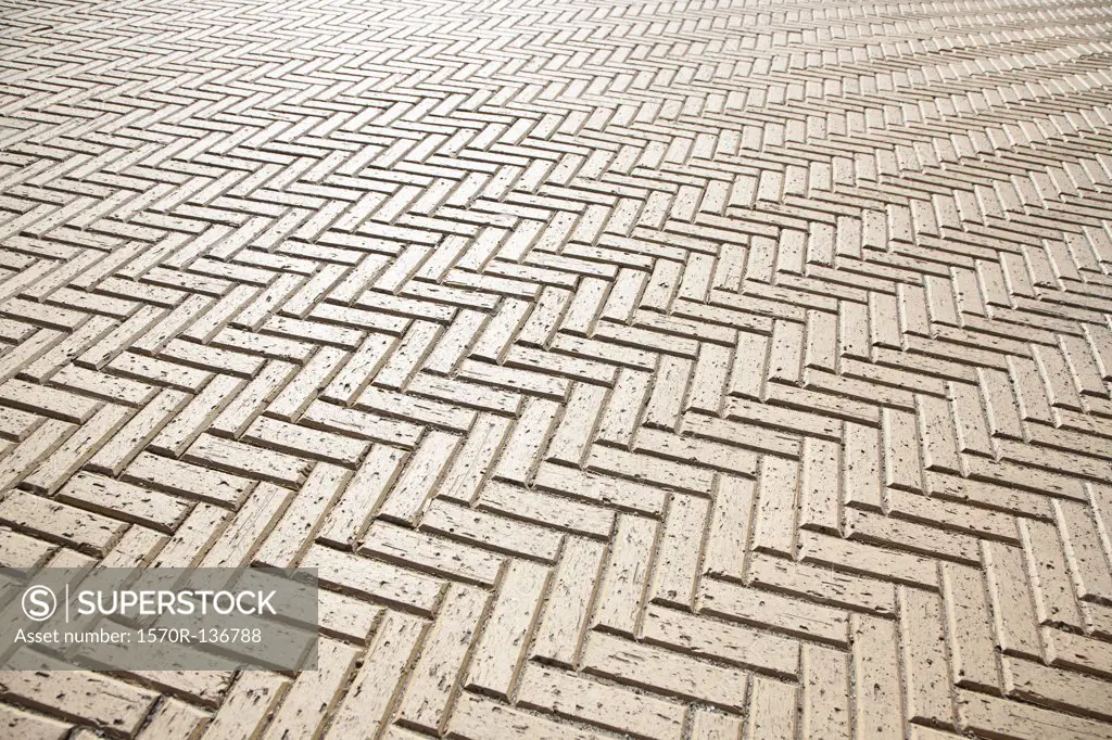 A tiled floor in a zigzag pattern, full frame