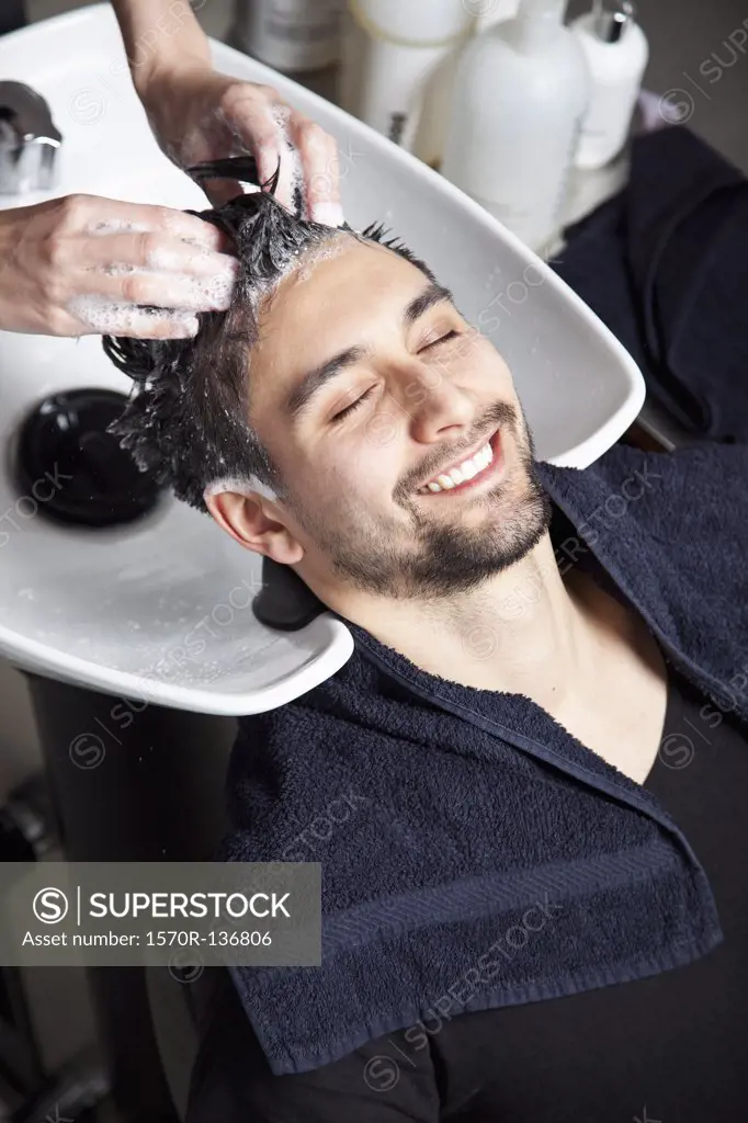 A man having his hair washed at a hair salon