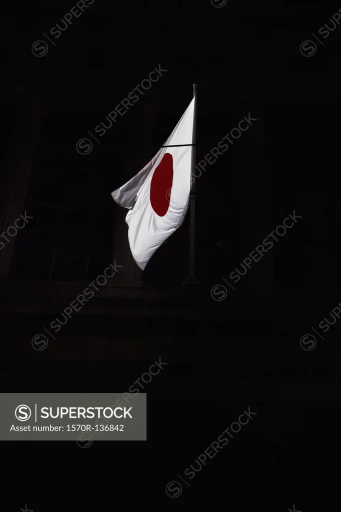 Flag of Japan in the air with a black background