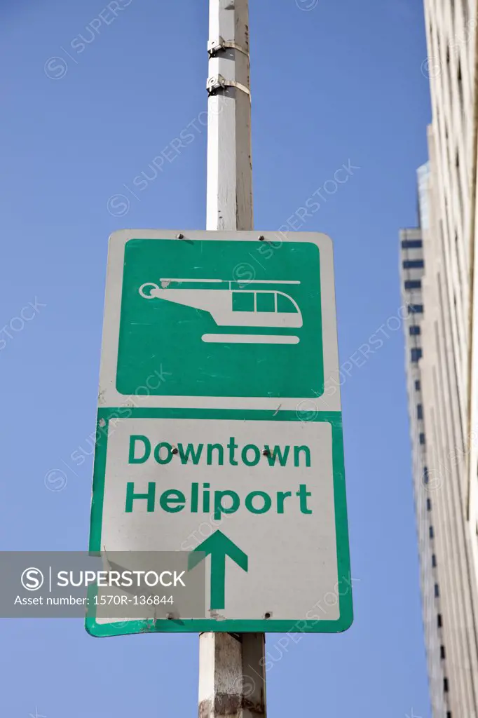 Sign saying 'Downtown Heliport' with direction arrow