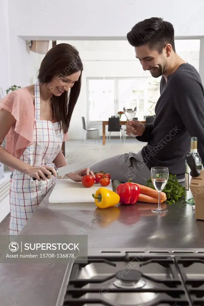 A young couple enjoying cooking together