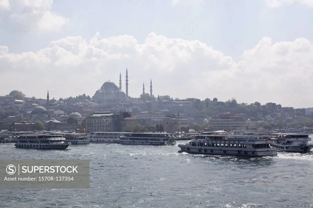 Ferries and tour boats on the Golden Horn River below the Suleymaniye Mosque, Istanbul, Turkey