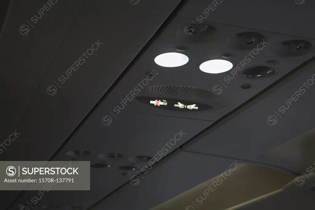 Illuminated signs on roof of a plane, fasten seat belt sign and no smoking sign