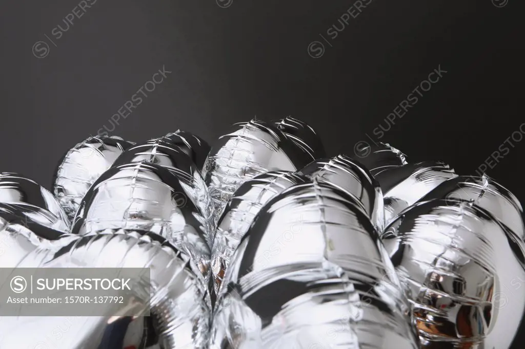 A bunch of silver helium balloons