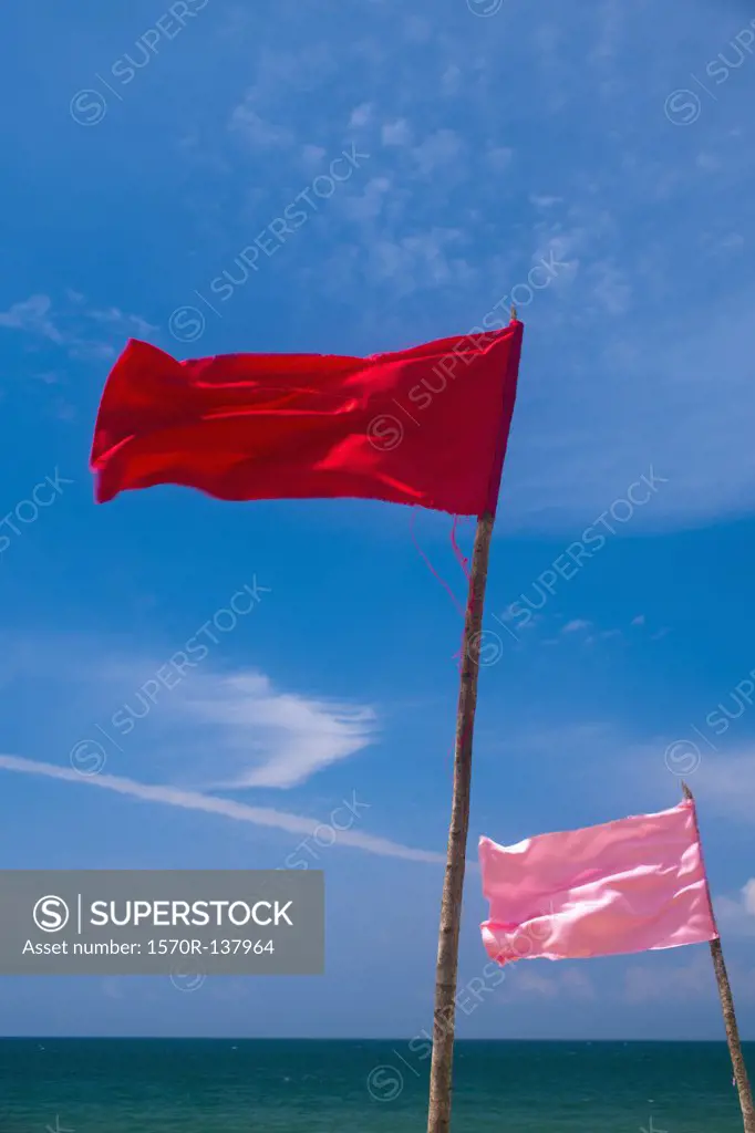 Colored flags flapping in the wind on a beach