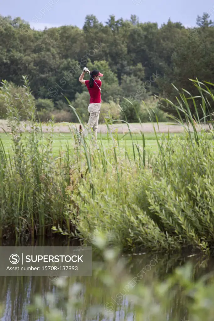 A female golfer teeing off