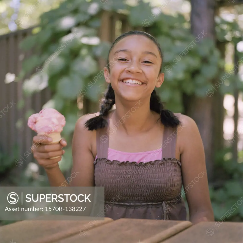 A teenage girl holding an ice cream cone