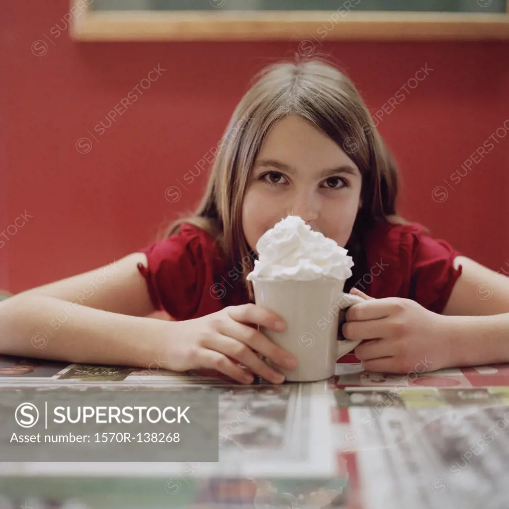A teenage girl with a mug of hot chocolate