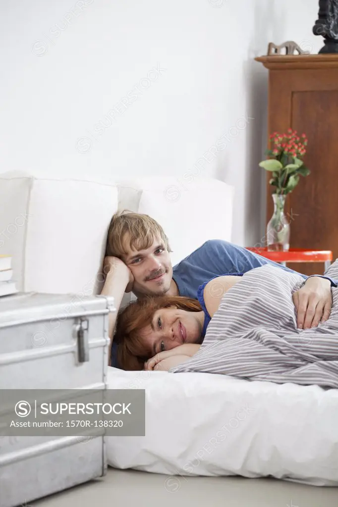A young couple lying in bed