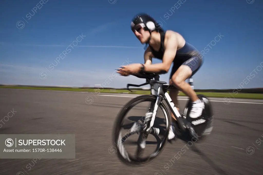 A cyclist on a racing bicycle, side view