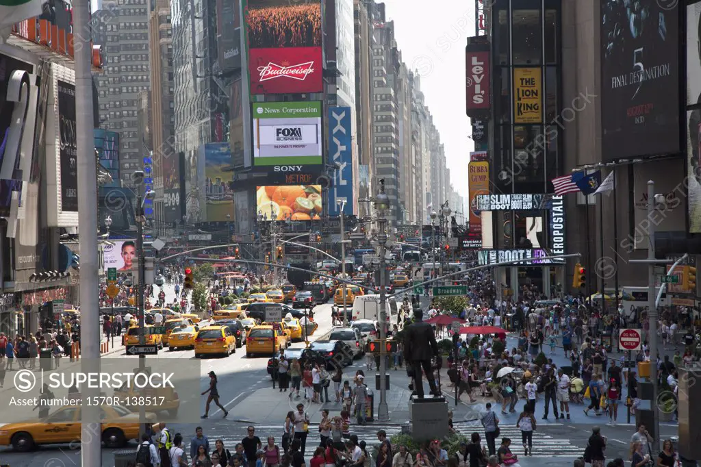 Times Square in New York, crowded with people and traffic