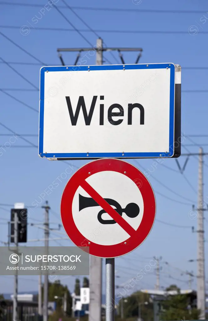 City sign for Vienna (Wien), Austria with a sign denoting no car horns
