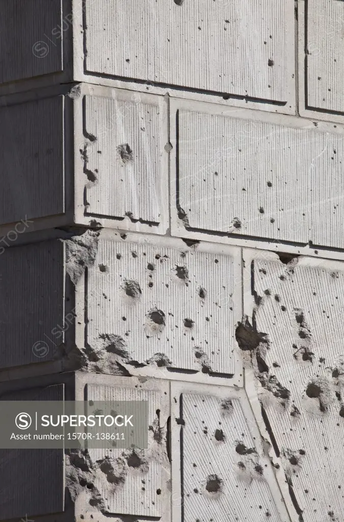 Bullet holes over facade of old building