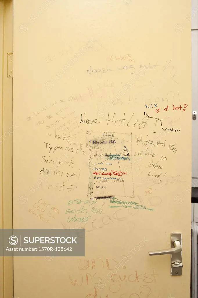 Handwritten graffiti on bathroom door