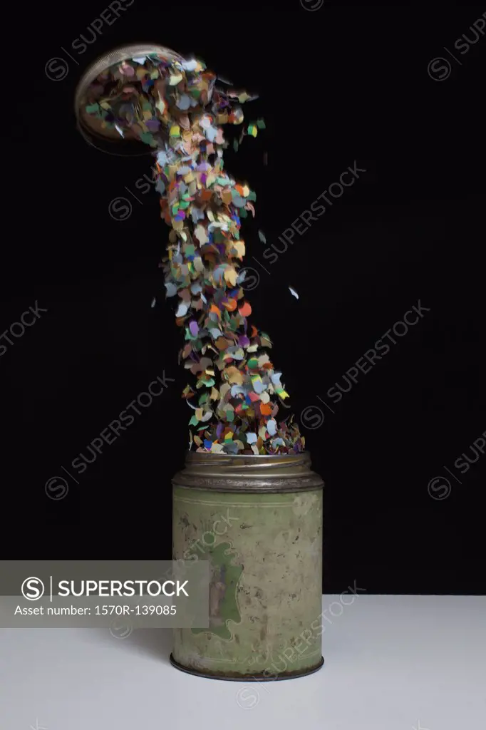 Confetti flying out of an old-fashioned metal tin
