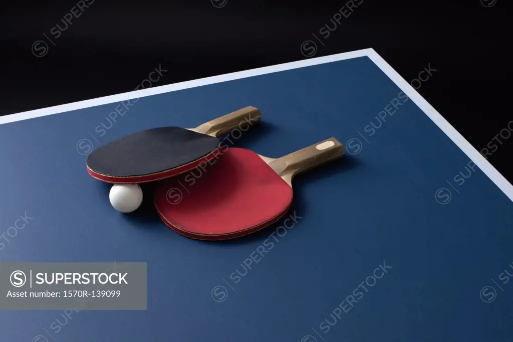 Table tennis bats and a ball on a table