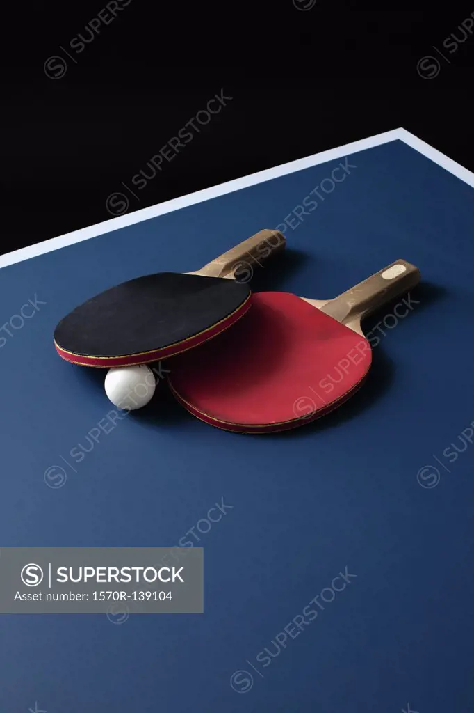 Table tennis bats and a ball on a table