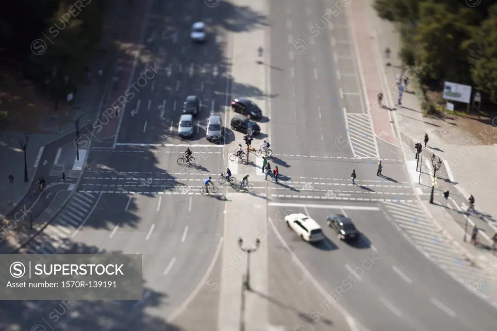 Cars, bicyclists and pedestrians at crossing, tilt-shift, Berlin, Germany