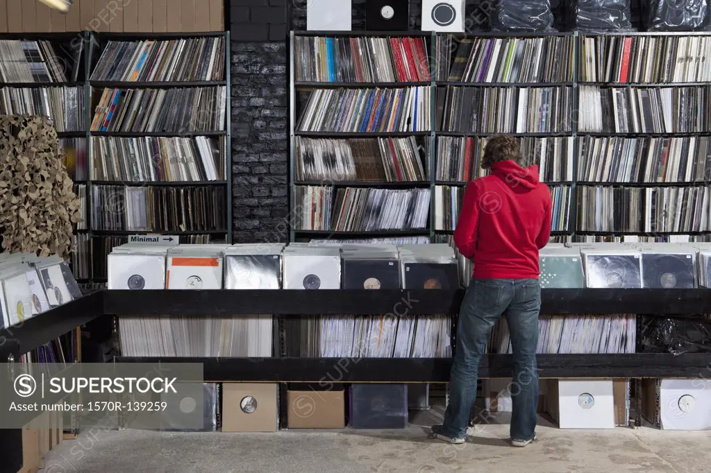 Rear view of young man in a record store