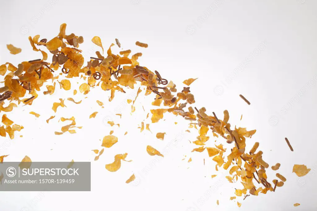 Chips, pretzels and savory snacks against a white background