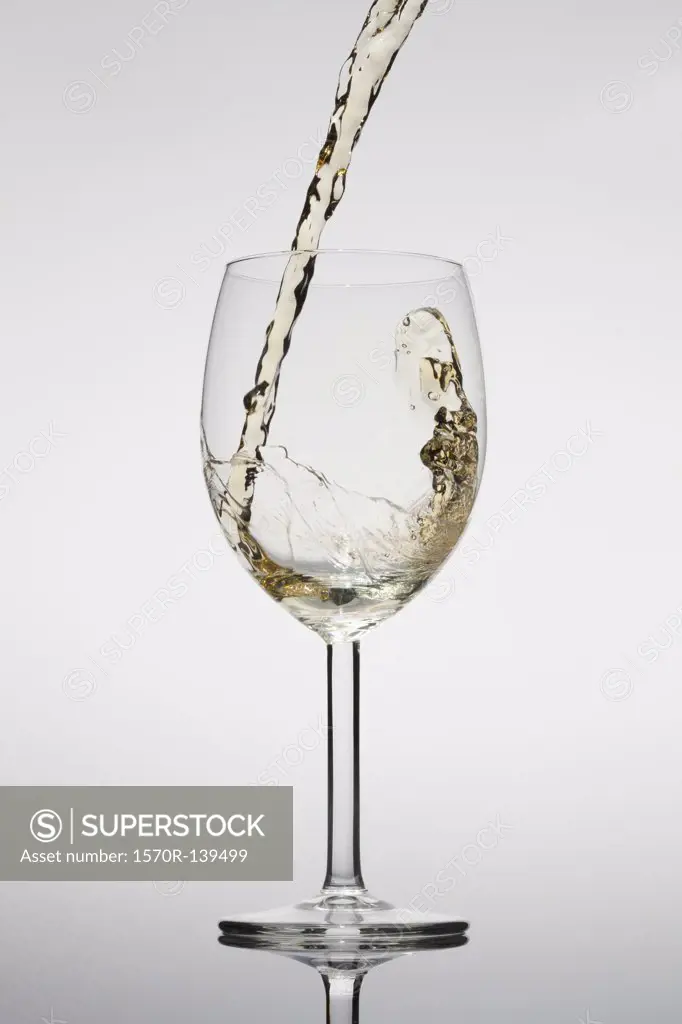 White wine being poured into a glass