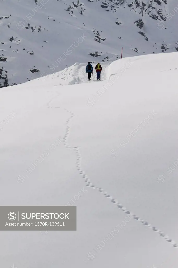 Two people in distance on snow hike