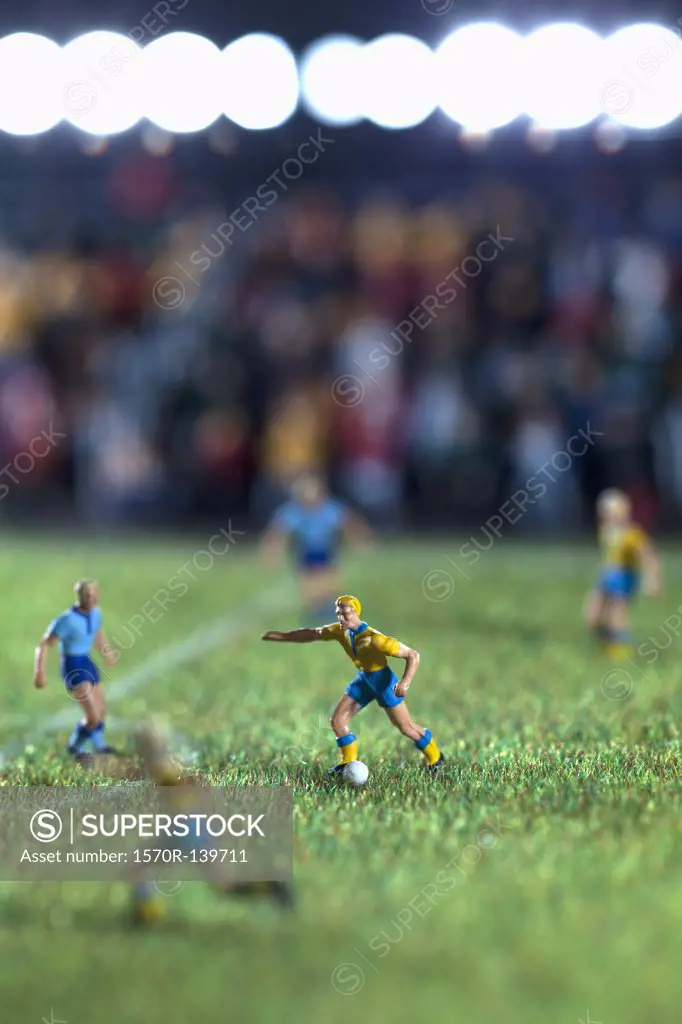Miniature figurines of two soccer teams playing a soccer match