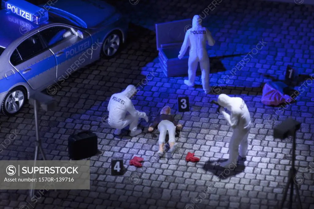 A diorama of a miniature forensics team collecting evidence at a murder scene