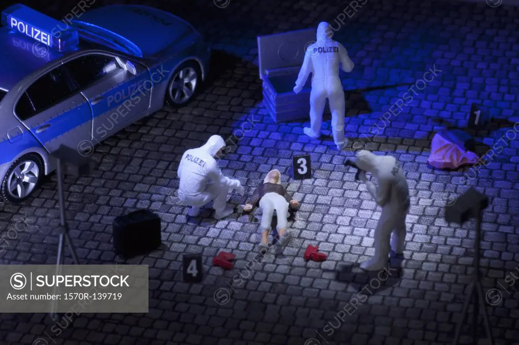 A diorama of a miniature forensics team collecting evidence at a murder scene